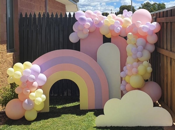 A balloon garland in pastel rainbow colours for a little girl's birthday.