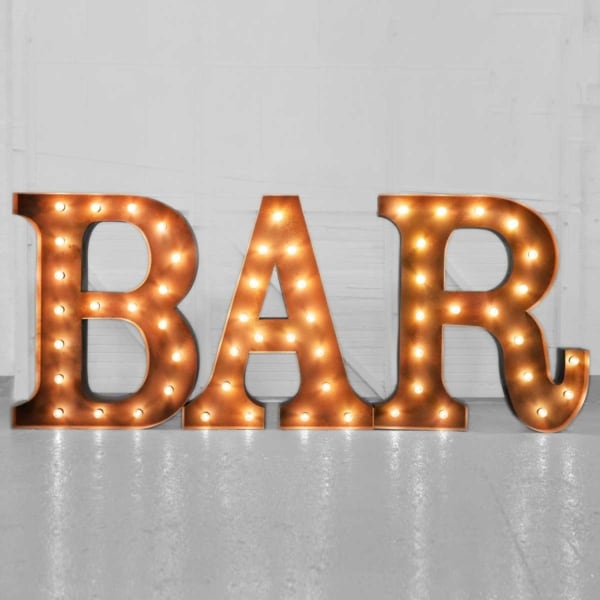 Bar light up letters in rustic gold against a white background.