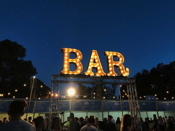 Bar light up letters under the stars at an outdoor concert in Perth.