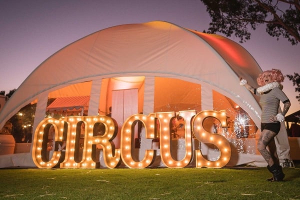 Giant golden light up letters at a circus-themed party