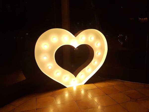 Giant LED light up heart on a tile floor.