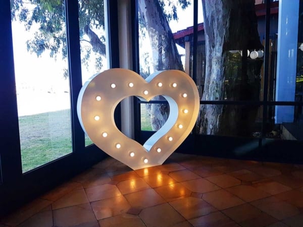 Giant LED light up heart in a sun room.