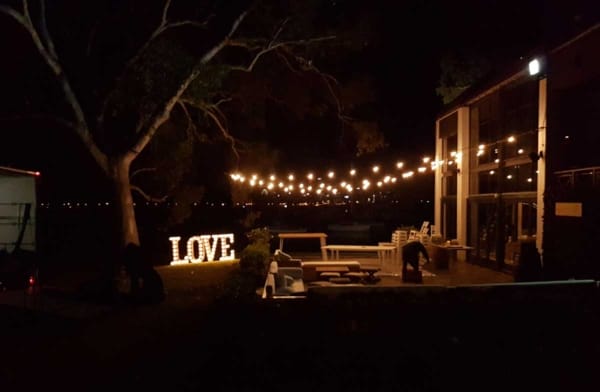 Giant light up love letters at a night time party