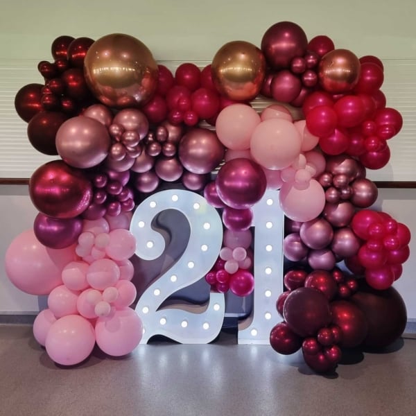 Giant LED number lights and pink balloons for a 21st birthday party.