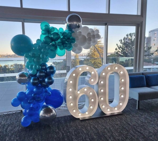 Giant number lights and blue balloons for a 60th birthday party