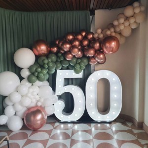 Large 50 light up number lights with green and pink balloons.