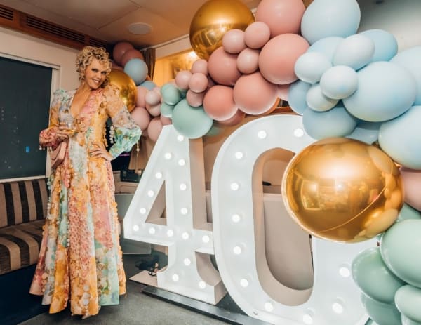 Giant LED 40 number lights with a pastel-hued balloon garland.