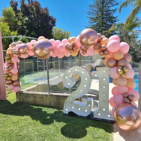 Giant white LED number lights with pink balloons in a Perth backyard.