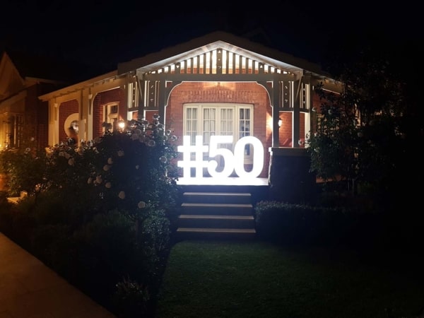 Giant light up numbers in the doorway at a 50th birthday party.