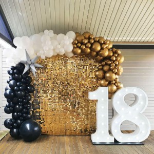 Giant light up numbers with balloon garland and gold shimmer wall.
