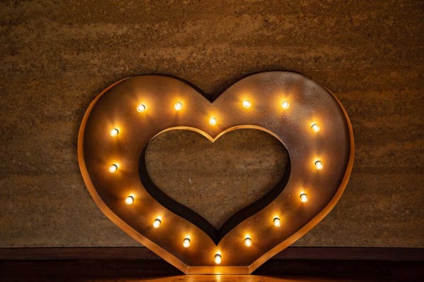 Light up rustic gold LED heart at an indoor event.