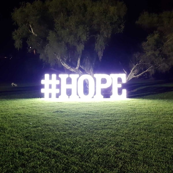 Giant white LED light up letters spelling out the word HOPE