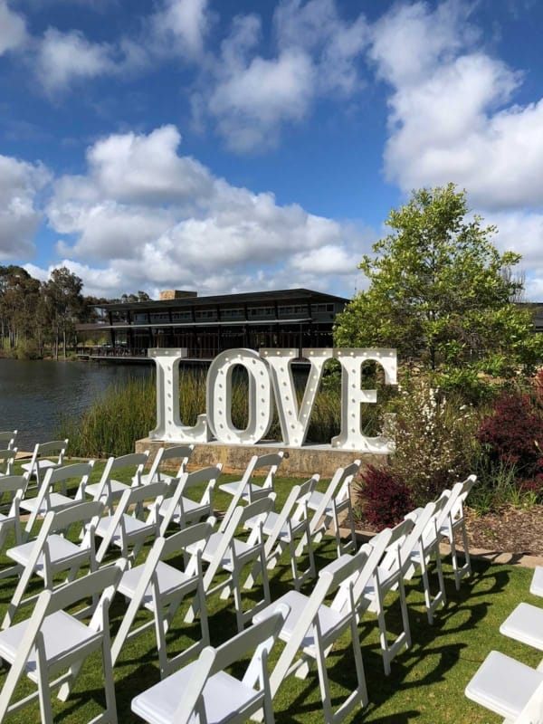 Giant LED love letters at a riverside wedding.
