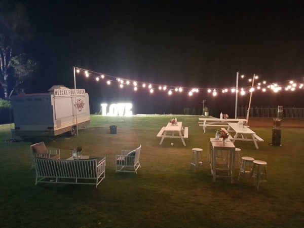 Light up love letters with festoon lights and picnic tables.