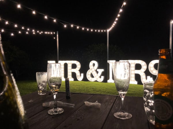 LED MR & MRS light up letters at a wedding with a table in the foreground.