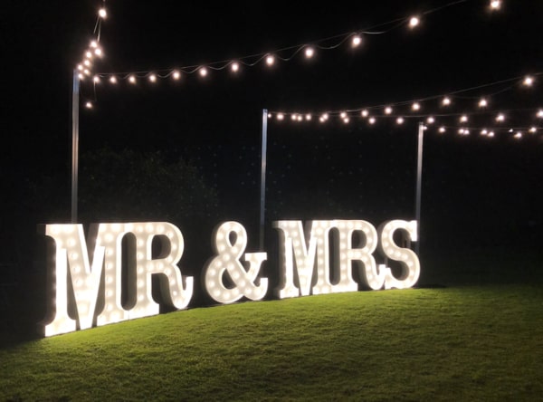 White LED MR & MRS light up letters under festoon lighting.