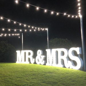 Giant white LED MR & MRS light up letters at a wedding.