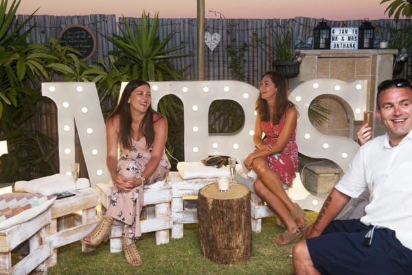 Large MR & MRS LED light up letters at a backyard wedding.