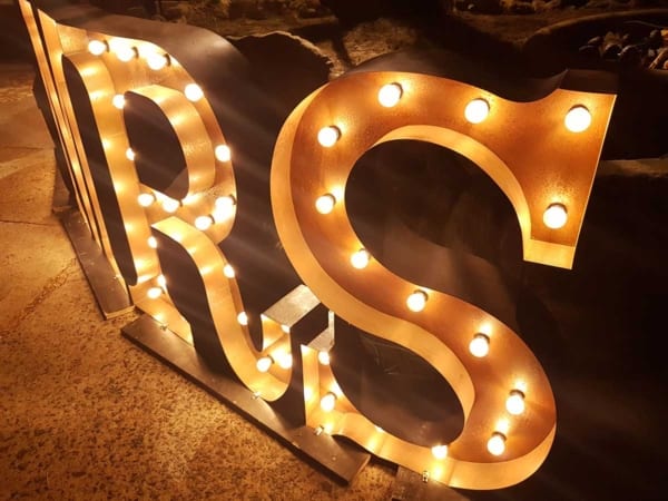 Close up of rustic gold light up MR & MRS letters.