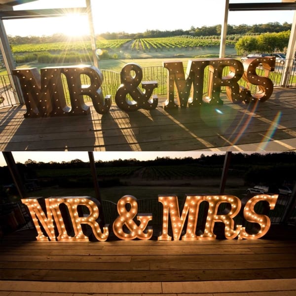 Night and daytime photos of giant rustic gold light up MR & MRS letters at Barrett Lane Function Centre.