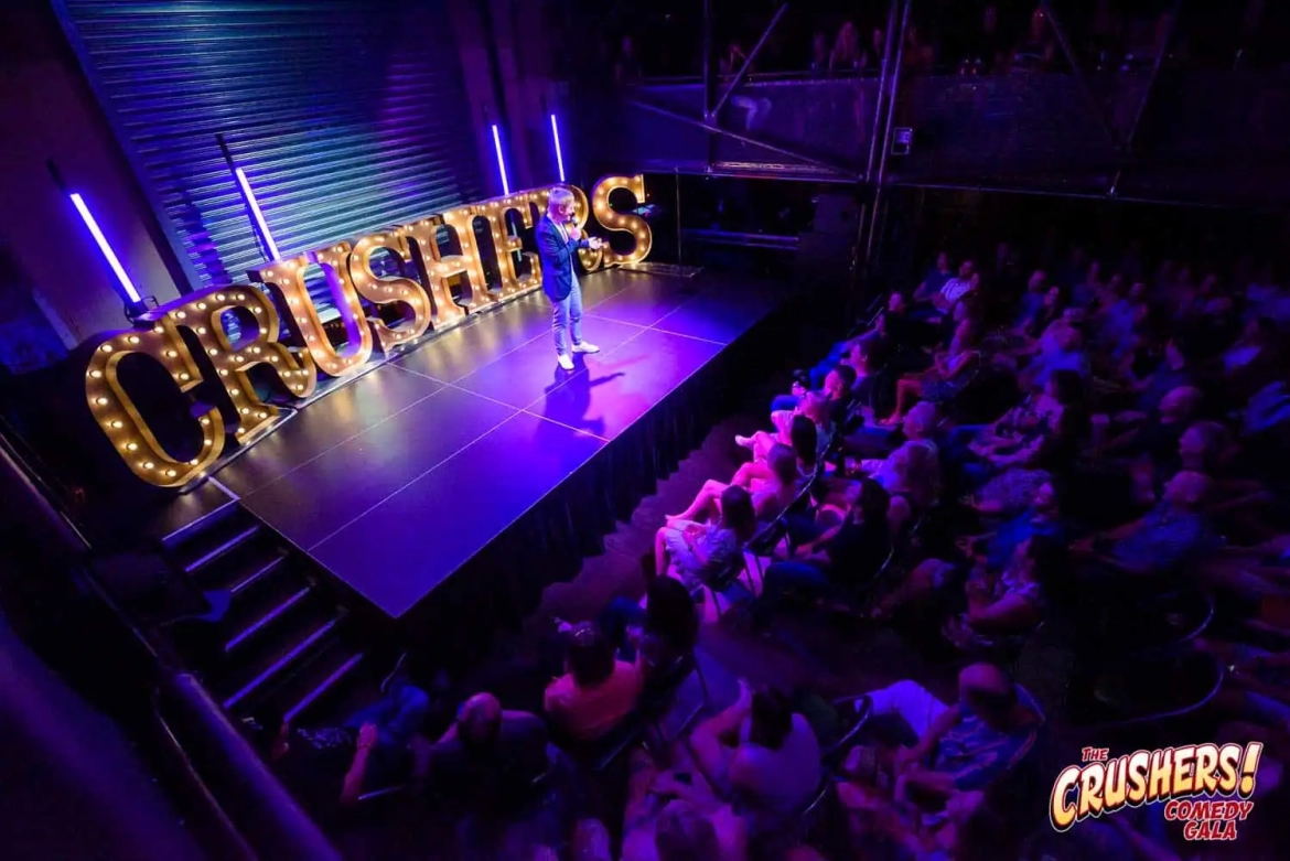 Giant-letters-at-comedy-show.webp
