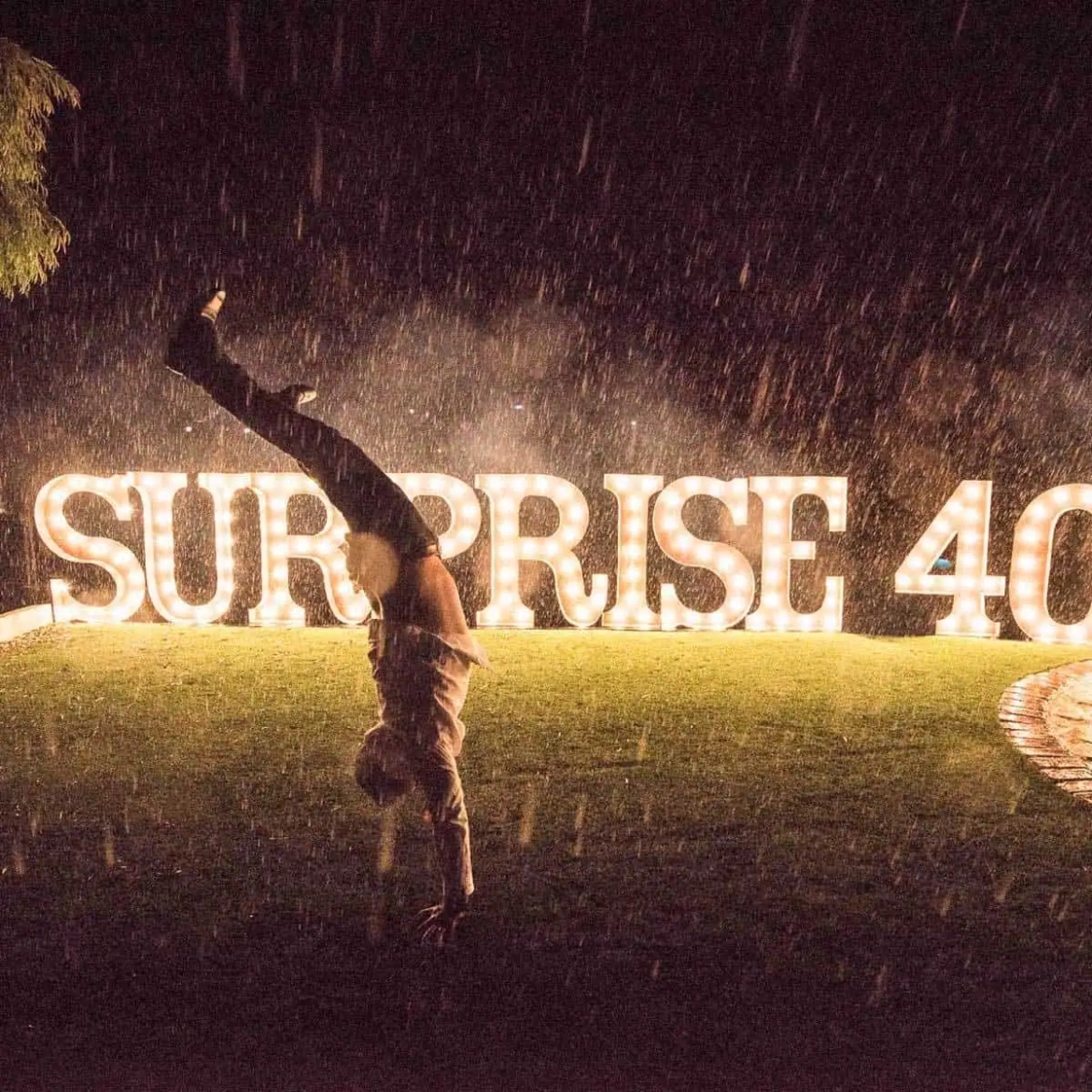 Giant-letters-on-lawn-in-rain.webp