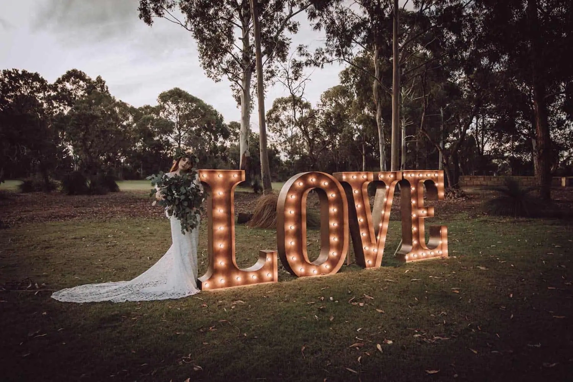 Giant-light-up-love-letters-with-bride.webp